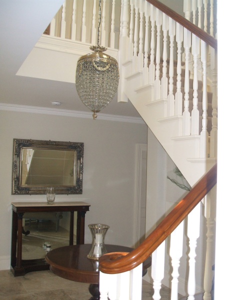 A cream stairs with a carpet finish with teak handrail.jpg